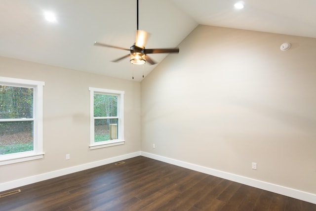 spare room featuring ceiling fan, dark wood-type flooring, and vaulted ceiling