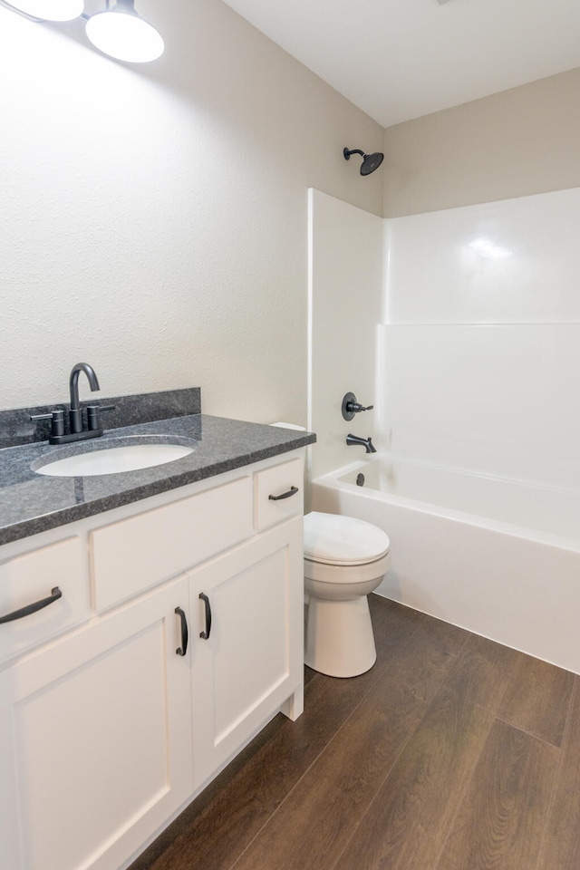 full bathroom with toilet, shower / bath combination, wood-type flooring, and vanity