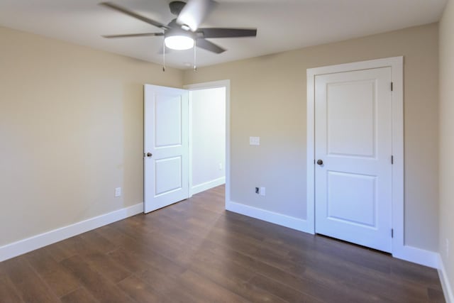 unfurnished bedroom featuring ceiling fan and dark hardwood / wood-style floors