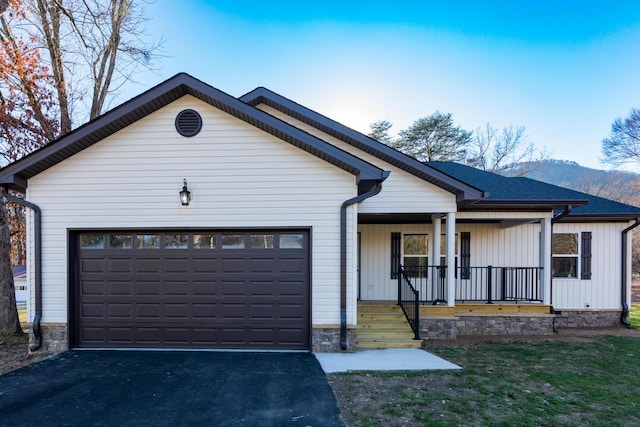 view of front of home with covered porch and a garage