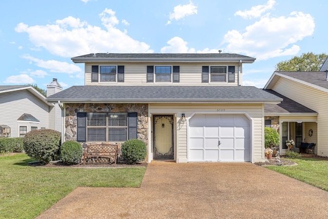 front of property with a front yard and a garage