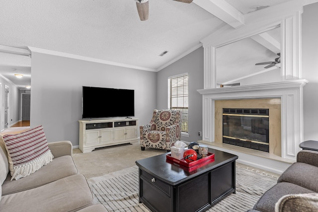 carpeted living room featuring vaulted ceiling with beams, a textured ceiling, ceiling fan, and crown molding