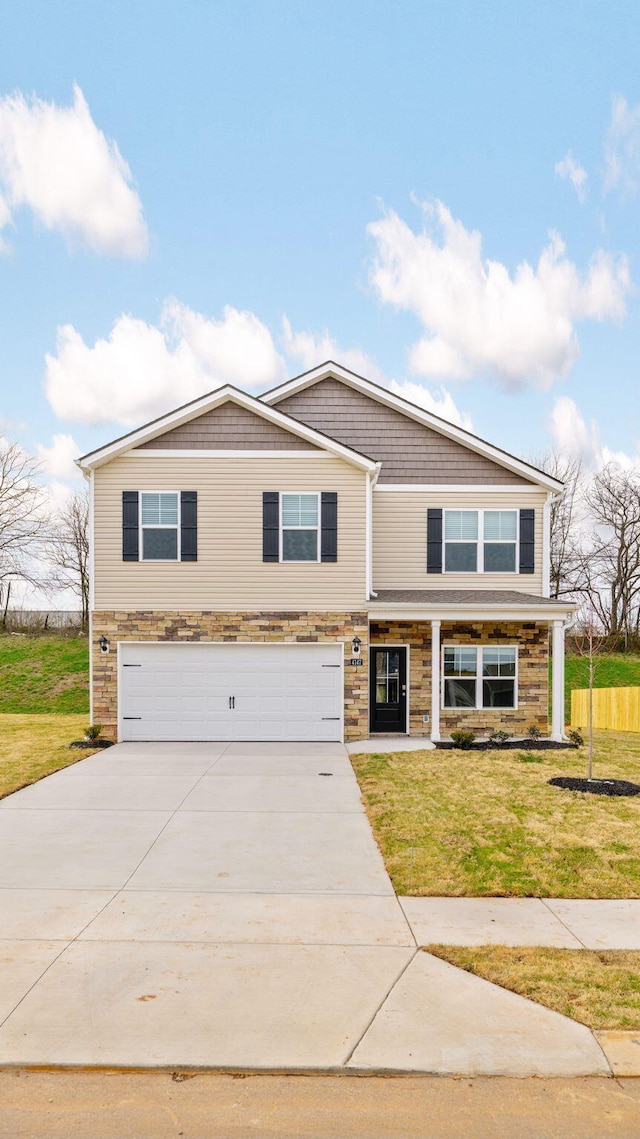 view of front of home with a front yard, an attached garage, and concrete driveway