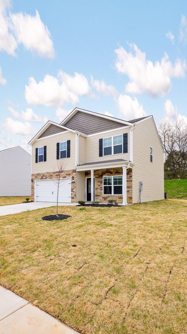 view of front of home with stone siding, an attached garage, concrete driveway, and a front yard