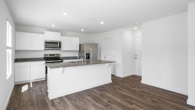 kitchen with white cabinetry, a kitchen island with sink, appliances with stainless steel finishes, and a sink