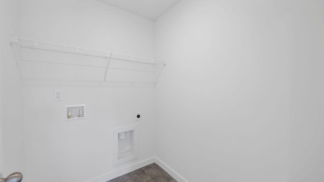 laundry area featuring laundry area, hookup for a washing machine, electric dryer hookup, and baseboards