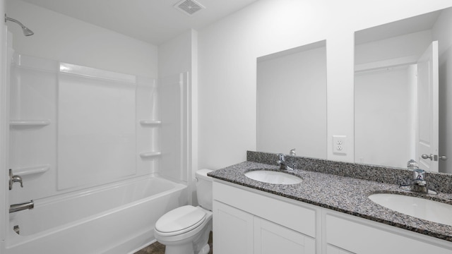 bathroom featuring a sink, visible vents, toilet, and double vanity