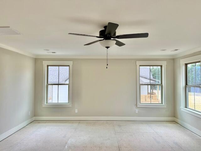 unfurnished room featuring ceiling fan, baseboards, and ornamental molding