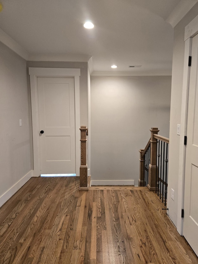 hallway with ornamental molding, recessed lighting, baseboards, and wood finished floors