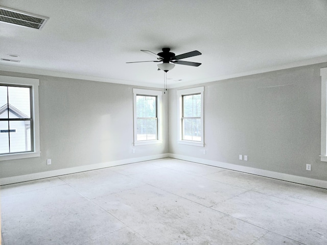 empty room featuring ceiling fan, crown molding, visible vents, and baseboards