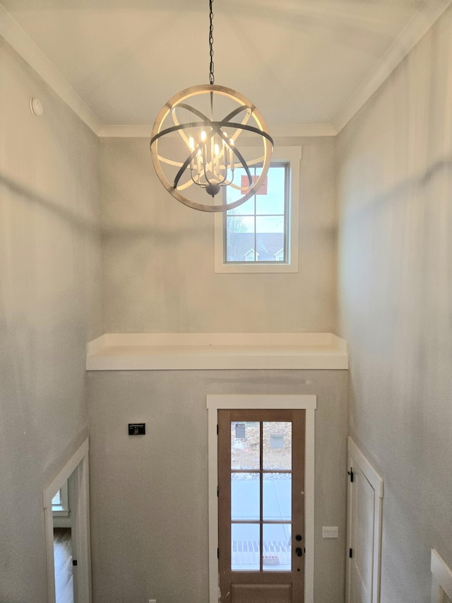 interior space featuring a chandelier and ornamental molding