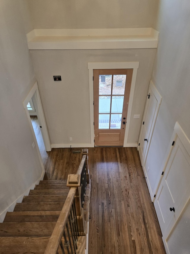 doorway with stairway, visible vents, baseboards, and wood finished floors