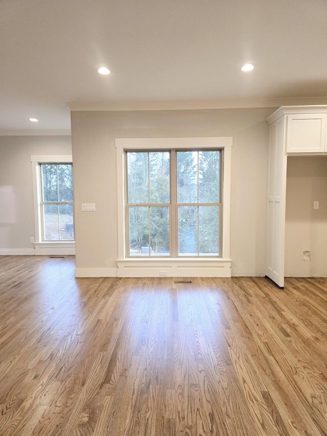 empty room with recessed lighting, plenty of natural light, and light wood finished floors