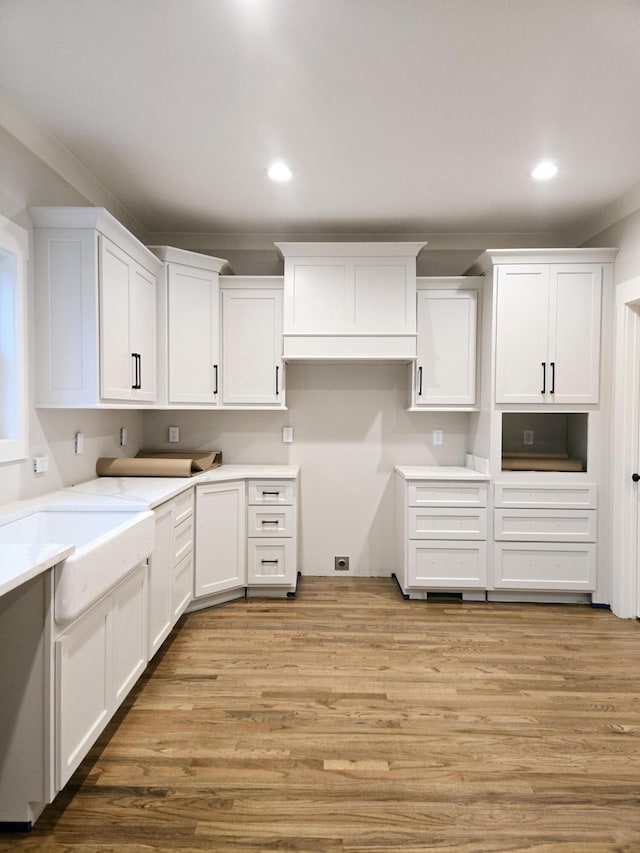 kitchen featuring light wood-style floors, recessed lighting, and white cabinets