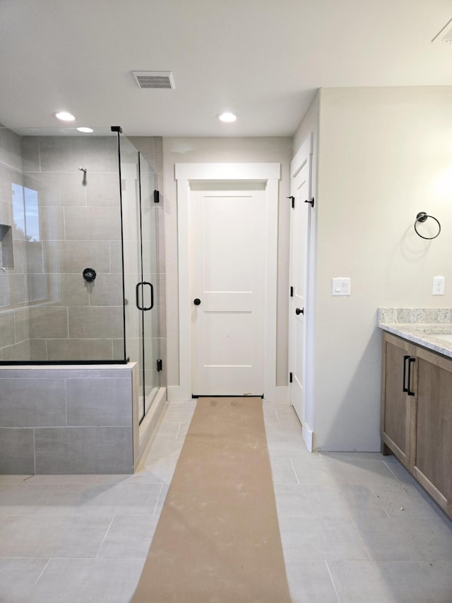 bathroom featuring recessed lighting, visible vents, a shower stall, and vanity