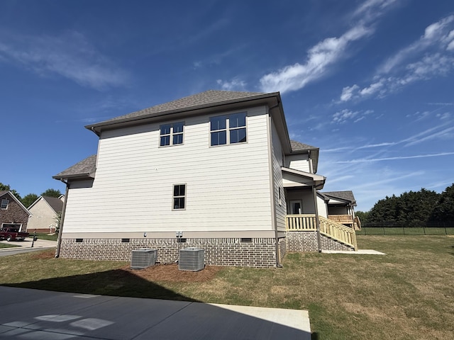 view of property exterior featuring fence, a yard, and crawl space