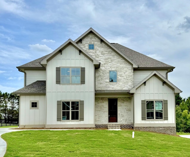269 Quartz Dr Unit 21, Chickamauga, GA 30707 - view of front of home with board and batten siding, a front yard, and a shingled roof