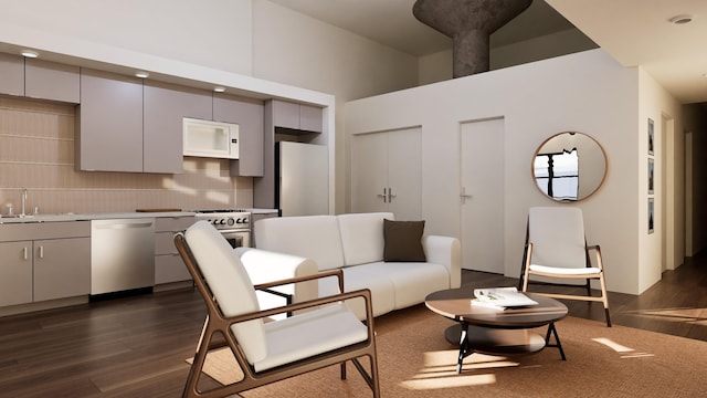 living room featuring a high ceiling and dark hardwood / wood-style floors