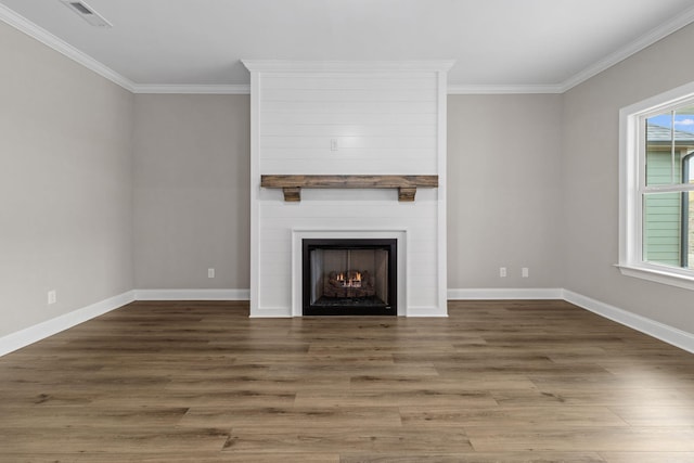 unfurnished living room with crown molding, a large fireplace, and dark hardwood / wood-style flooring