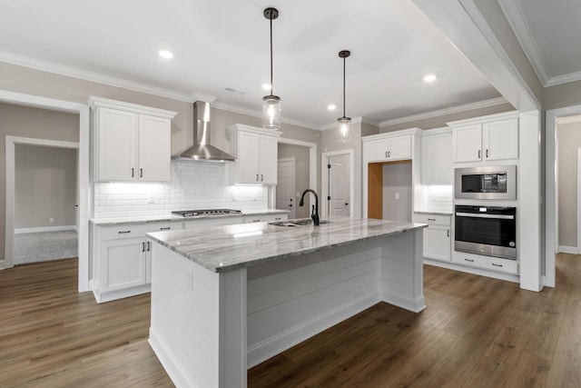 kitchen with sink, white cabinetry, appliances with stainless steel finishes, and wall chimney exhaust hood