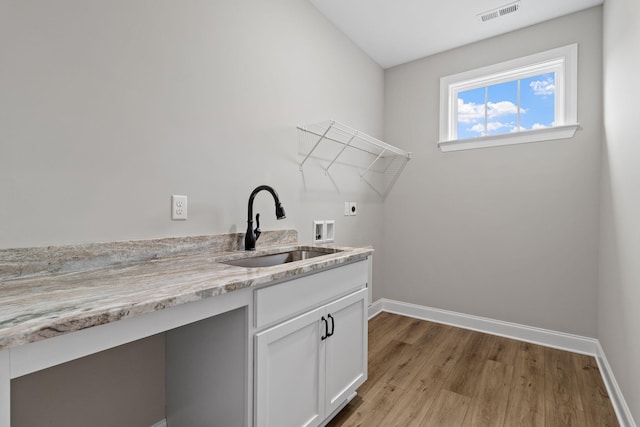 laundry room featuring sink, hookup for an electric dryer, light hardwood / wood-style floors, and washer hookup