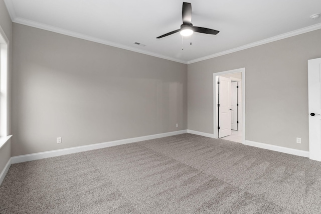 empty room featuring crown molding, light colored carpet, and ceiling fan