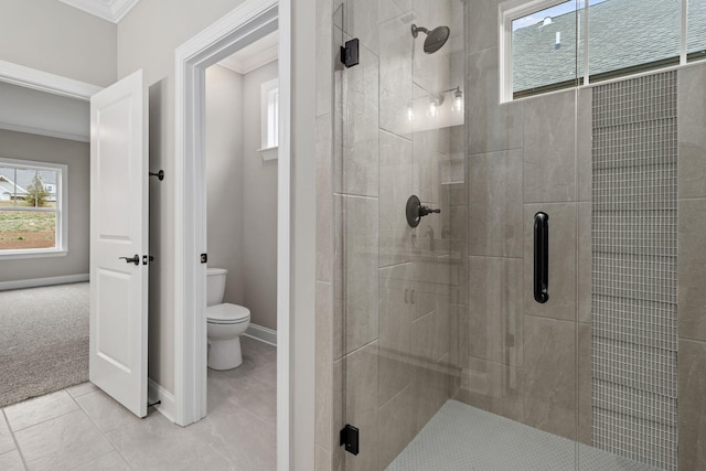 bathroom featuring ornamental molding, toilet, walk in shower, and tile patterned floors