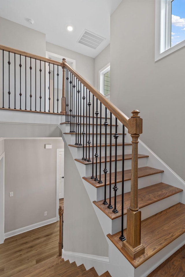 staircase featuring wood-type flooring