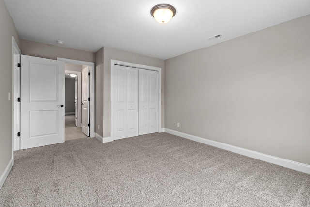 unfurnished bedroom with a closet and carpet