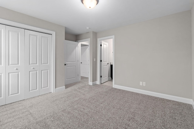 unfurnished bedroom featuring a closet and light carpet