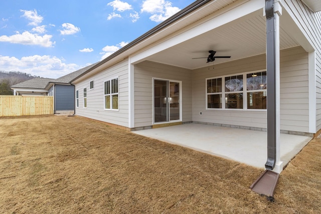 back of property featuring a patio area, a lawn, and ceiling fan