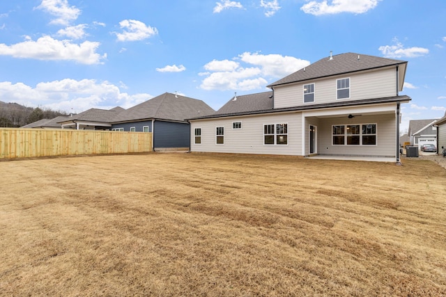 rear view of property with ceiling fan, a patio area, a lawn, and central AC