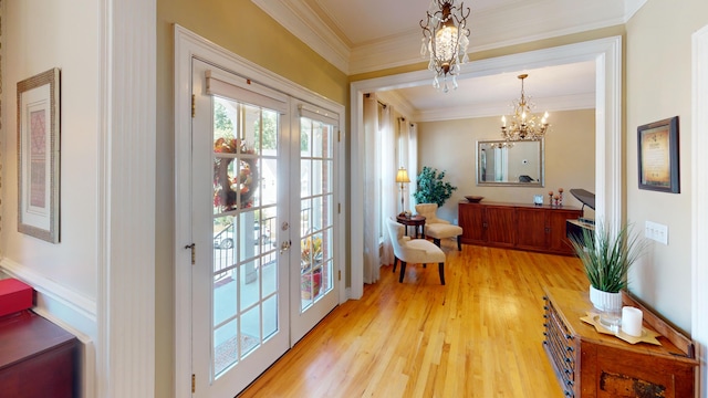 doorway featuring light wood-type flooring, crown molding, and a chandelier