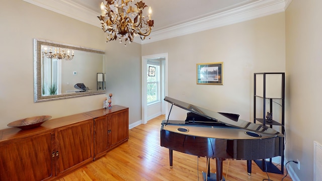 miscellaneous room with a notable chandelier, crown molding, and light hardwood / wood-style floors