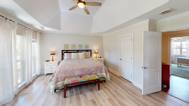 bedroom featuring light hardwood / wood-style flooring, ceiling fan, and multiple windows