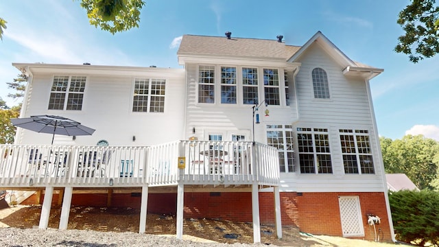 rear view of house featuring a wooden deck