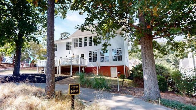 view of front facade with a wooden deck