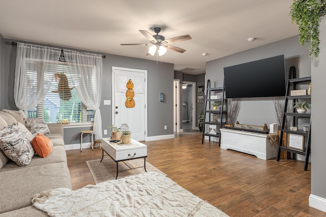 living room featuring ceiling fan and hardwood / wood-style floors