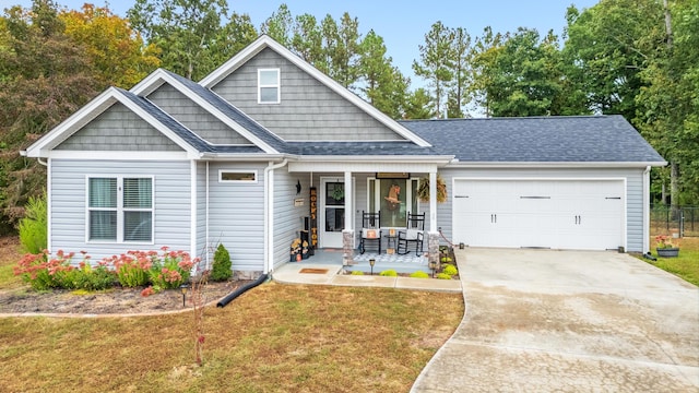 craftsman house featuring a front yard, a garage, and a porch