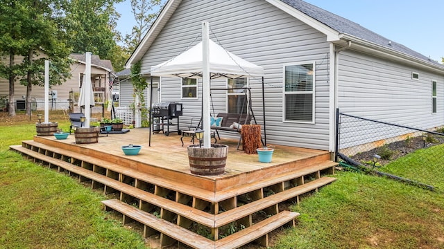 back of property with a wooden deck and a yard