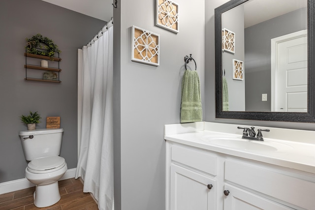 bathroom featuring wood-type flooring, vanity, and toilet