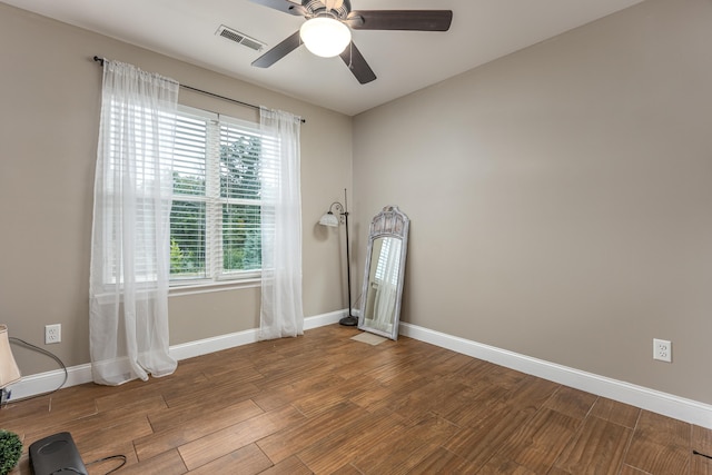 spare room featuring ceiling fan, plenty of natural light, and hardwood / wood-style floors