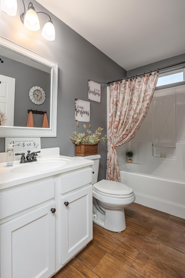 full bathroom with vanity, toilet, shower / bath combo with shower curtain, and hardwood / wood-style flooring