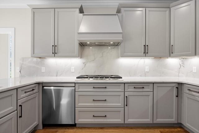 kitchen featuring premium range hood, gray cabinets, and backsplash