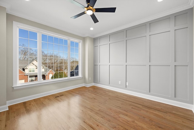 empty room with light wood-type flooring, ceiling fan, and crown molding