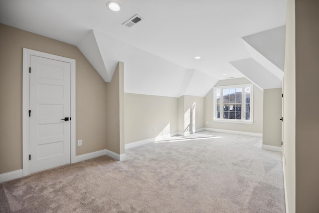 bonus room featuring light colored carpet and vaulted ceiling