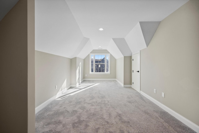 additional living space with lofted ceiling and carpet floors