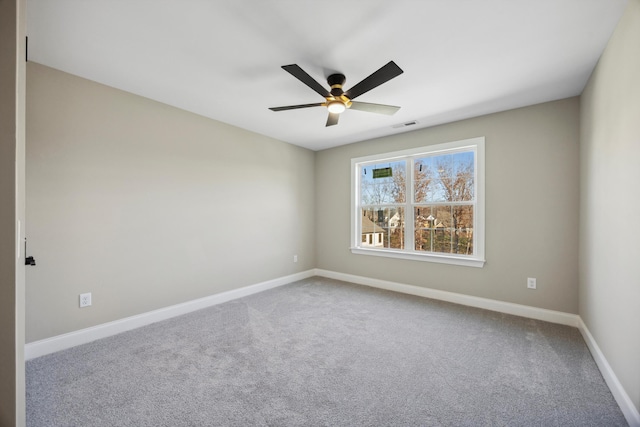 carpeted empty room featuring ceiling fan