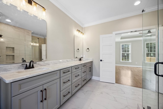 bathroom with ornamental molding, ceiling fan, vanity, and a shower with shower door