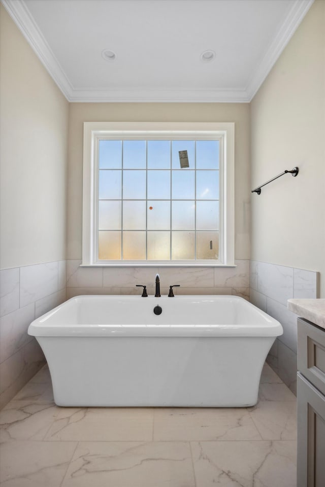 bathroom with a washtub, plenty of natural light, and crown molding